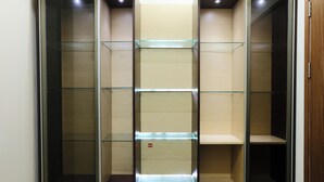A walk-in closet with multiple shelves and drawers, featuring a combination of open and closed storage options. - Spacious 3Br Combined Unit At Pinewood Apartment (Cileunyi)
