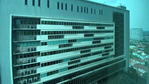 A modern building with a grid-like facade, multiple windows, and a flat roof. - Modern Look And Comfort 2Br Kemang Village Apartment (Jakarta)