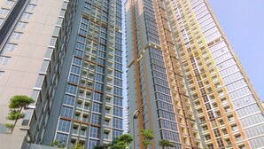 A high-rise building with multiple floors, featuring a modern architectural design with large windows and balconies. - Comfort And Modern 1Br At Gold Coast Apartment (Jakarta)