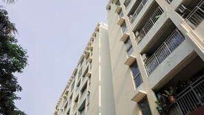 A multi-story residential building with balconies, windows, and some potted plants. - Minimalist Studio Taman Semanan Indah Cengkareng Apartment (Jakarta)