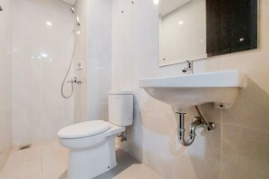 A modern bathroom with a toilet, sink, and shower. - Gorgeous And Homey 2Br Serpong Garden Apartment (Cisauk)