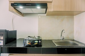 Studio | Private kitchen | Full-size fridge, stovetop - Homey And Good Deal Studio Serpong Garden Apartment (Cisauk)