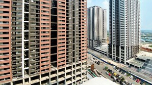 A high-rise building with multiple floors, large windows, and a modern architectural design. - Spacious And Comfy 2Br With Extra Room At Meikarta Apartment (Cikarang)