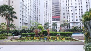 A landscaped garden with a 'CORBISVIEW' sign, surrounded by tall residential buildings. - Cozy And Comfort Living 2Br Green Bay Pluit Apartment (Jakarta)