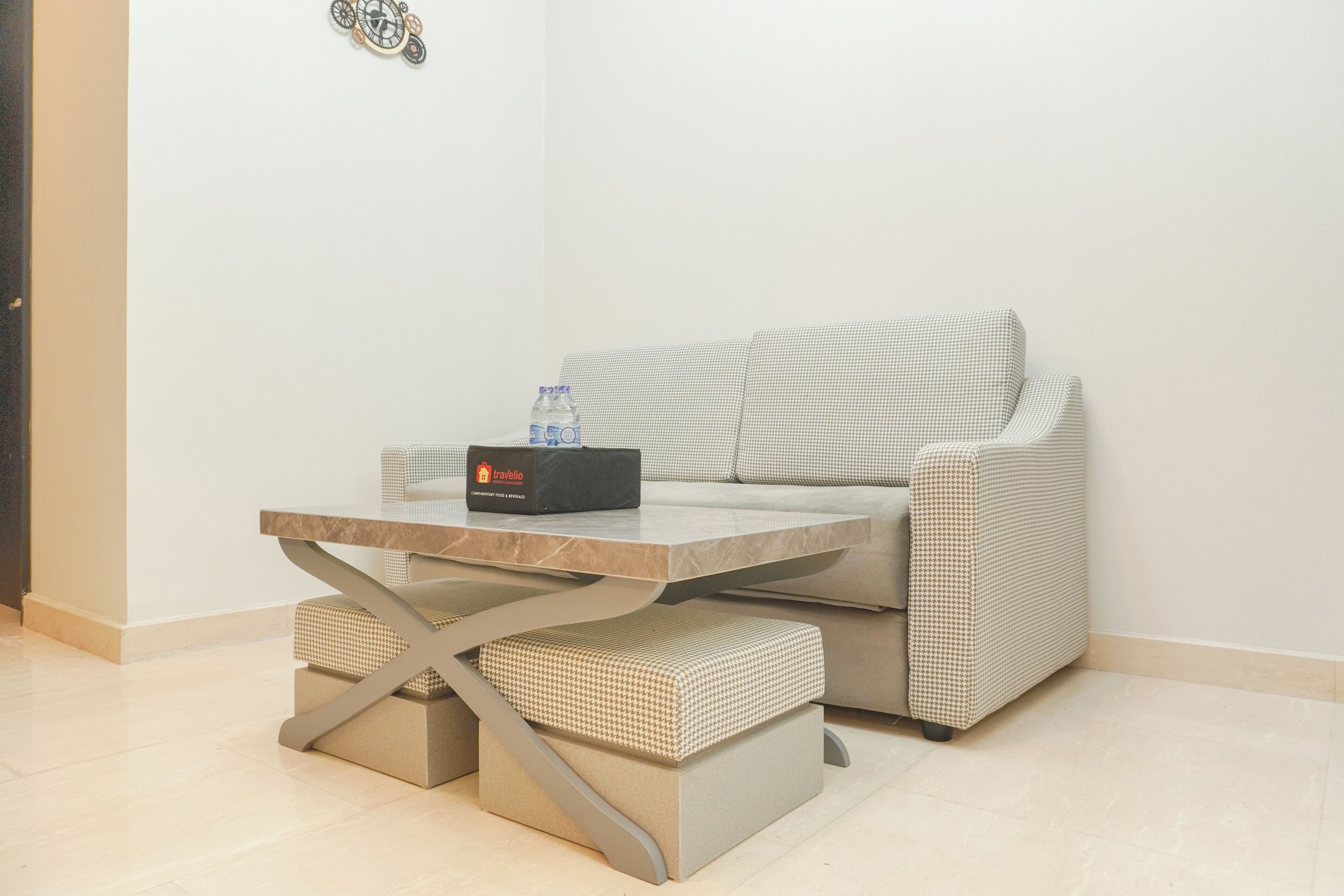 A modern living area with a sofa, a small table, and a bench.