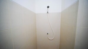 A shower with a handheld hose in a tiled bathroom. - Spacious 2Br Combine Unit At Bale Hinggil Apartment (Surabaya)