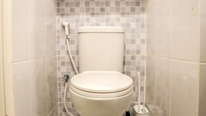 A bathroom with a toilet, a shower, and a bidet. - Modern And New Studio At Tokyo Riverside Pik 2 Apartment (Teluknaga)