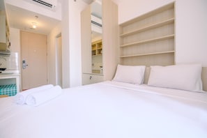 A hotel room with a bed, a bathroom, and a wardrobe. - Comfy And Best Choice Studio Apartment Tokyo Riverside Pik 2 (Teluknaga)