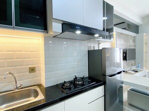 Studio | Private kitchen | Full-sized fridge, stovetop - Best Deal And Cozy Studio Room Transpark Cibubur Apartment (Depok)