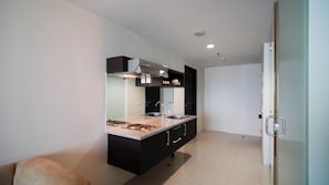 Enjoy cooking in this well-equipped kitchen with a central island, stove, and oven, as well as two sinks and a range hood.