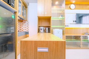 Kitchen features an oven, coffee machine, and microwave.