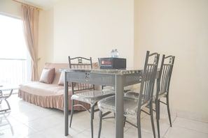 Enjoy meals in the dining area with a table and four chairs, perfect for a quiet evening in.