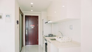 A modern kitchen with a white countertop, a sink, and a dishwasher. - Wonderful And Strategic Studio Apartment Sky House Alam Sutera (Tangerang)
