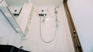 A modern bathroom with a shower, a control panel, and a mirror. - Wonderful And Strategic Studio Apartment Sky House Alam Sutera (Tangerang)