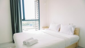A neatly made bed with white linens and pillows, a wooden headboard, and a view of a building outside through a window with curtains. - Wonderful And Strategic Studio Apartment Sky House Alam Sutera (Tangerang)