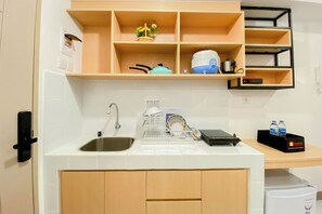 Studio | Private kitchen | Full-size fridge, stovetop, rice cooker, cookware/dishes/utensils - Comfortable Stay Studio At Tokyo Riverside Pik 2 Apartment (Teluknaga)