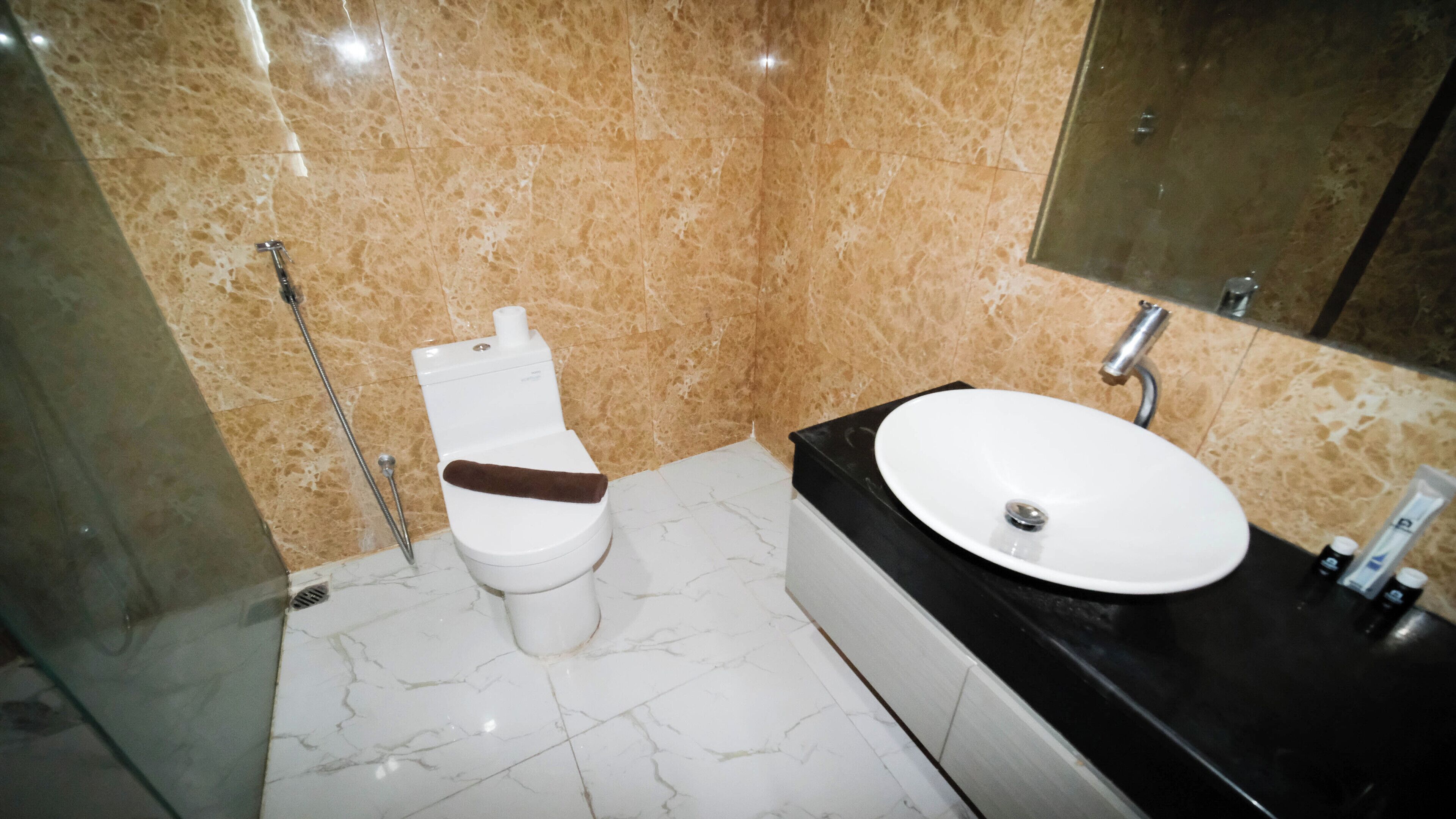 A bathroom with a toilet, sink, and shower.
