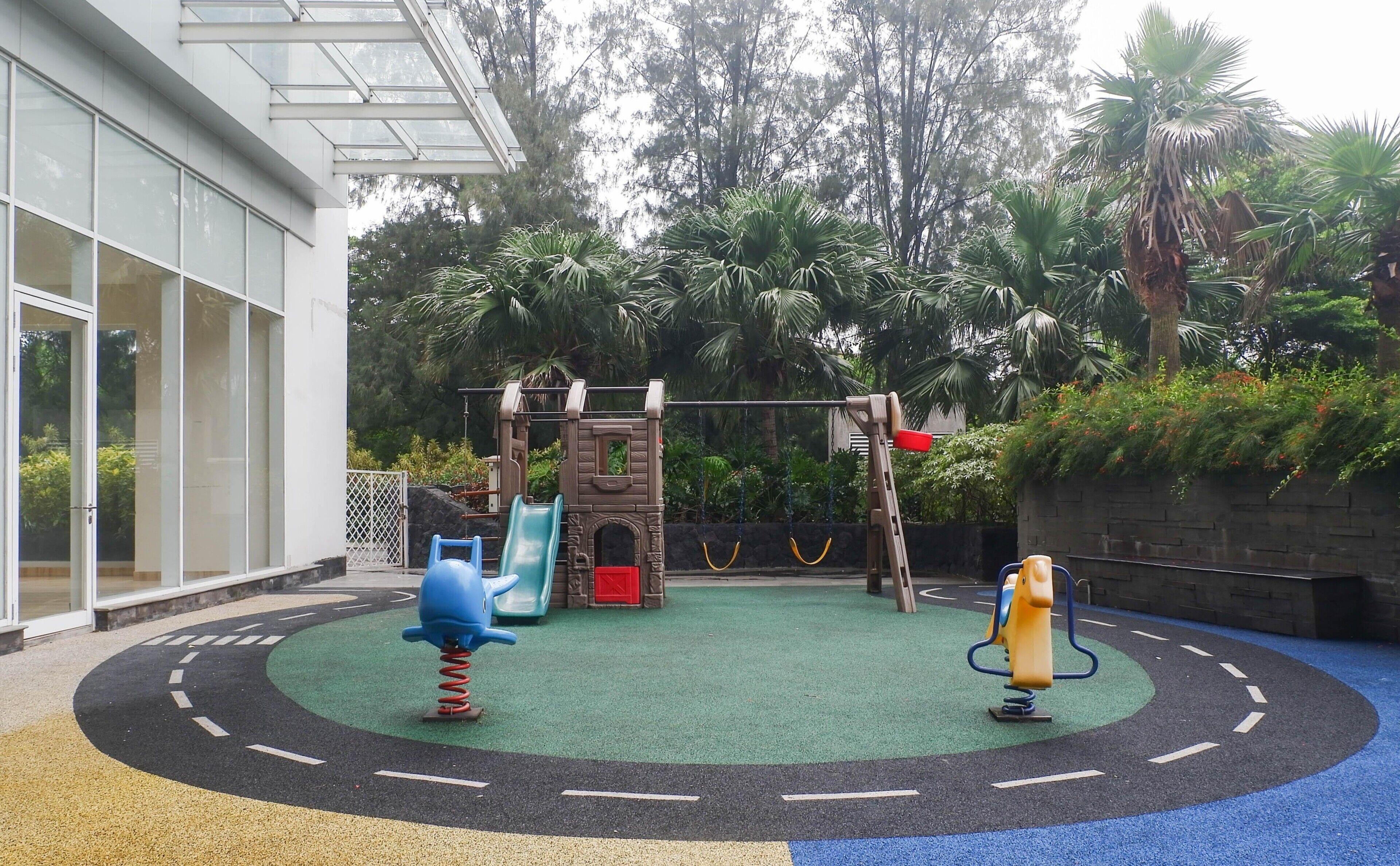 A playground with a slide, swings, and a climbing structure.