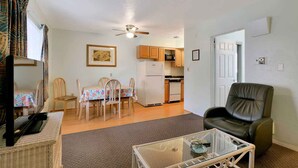 A compact living space with a dining area, kitchen, and seating area.