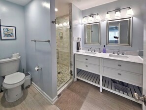 A bathroom with a toilet, bidet, shower, vanity with mirrors, and a rug. - New Listing✦Walk to Beach ✦ Corolla Light Resort Pools✦ Hot Tub ✦ Bikes ✦ Kayaks (Corolla)