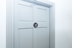 A white door with a black number "11" and the text "592 HOSPITALITY INC." above it.