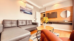 Comfort Apartment | Living area | 102-inch LED TV with satellite channels, Netflix, MP3 dock