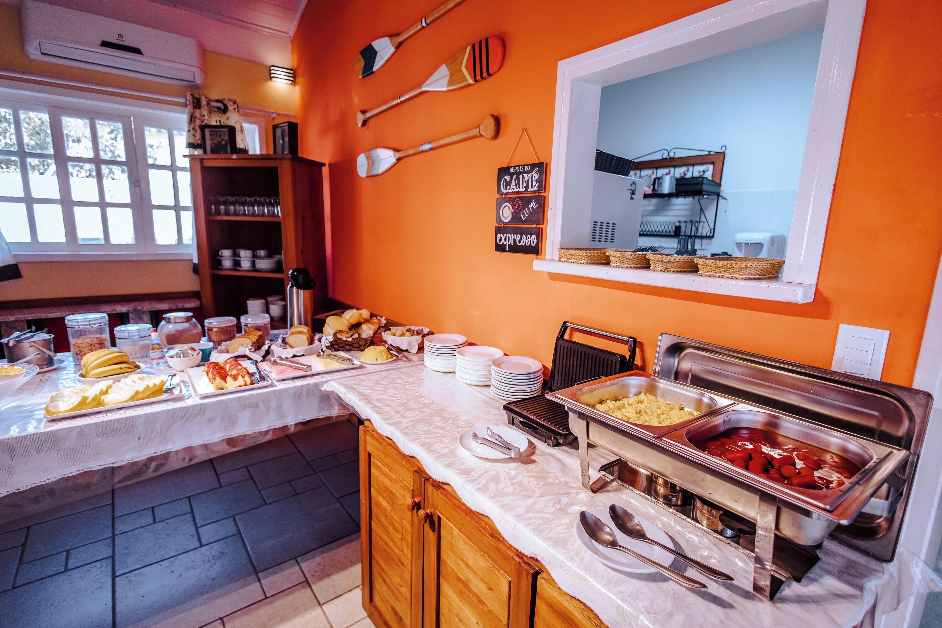A buffet setup with various food items and utensils.
