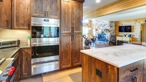 A modern kitchen with wooden cabinets, stainless steel appliances, and a large island. - Alma Mountain Getaway w/ Private Hot Tub & Views (Alma)