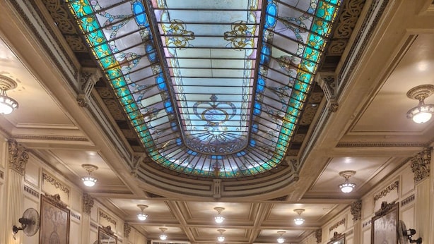 A grand interior with a central glass dome ceiling, multiple dining areas, and a reflective floor. - Lapinha 40 graus (Rio de Janeiro)