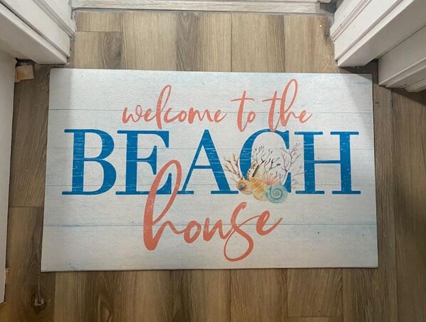 A welcome sign for a beach house. - The Good Times House (Calverton)