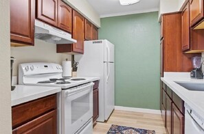 Enjoy cooking in this well-equipped kitchen with a stove, oven, and refrigerator.