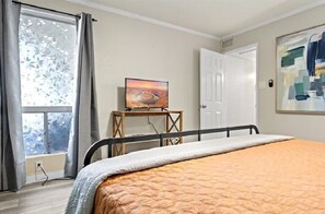 Relax in this inviting space with a large bed and a mounted television.