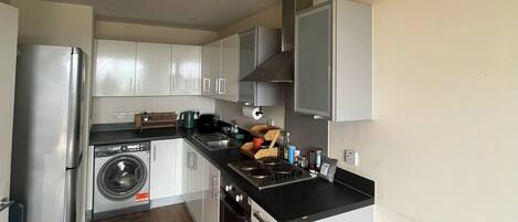 Fridge, stovetop, toaster, cookware/dishes/utensils