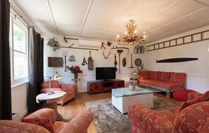 Relax in a cozy living room with a comfortable seating area, flat-screen TV, and decorative touches throughout.