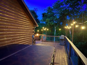 A wooden deck with a metal railing, a barbecue area, and string lights. - Beautiful Views. 10 Min To Gatlinburg and PF, WIFI (Sevierville)