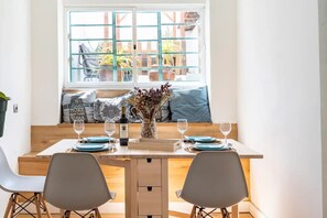 Enjoy a romantic meal for two in this beautifully set dining area with a view of the outdoor space.