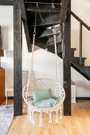 Relax in a stylish macramé chair with a comfortable cushion.