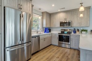 Enjoy cooking in this well-equipped kitchen with a refrigerator, microwave, and oven.