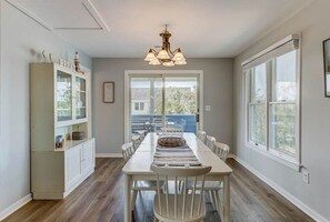 Enjoy meals with family and friends in this spacious dining area, featuring a long table and comfortable seating for six.