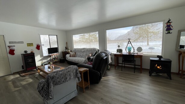A living room with a fireplace, a sofa, a coffee table, and a TV.
