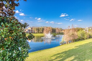 Surrounded by mature trees and a tranquil pond with a central fountain, this serene outdoor space offers a peaceful retreat.