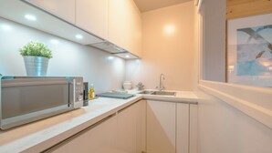 A modern kitchen with a built-in microwave, a sink, and a potted plant. - Apt Du Golf Du Mont d'Arbois in Megeve, near ski lift, Megeve (Chamonix), France (Megeve (Chamonix))