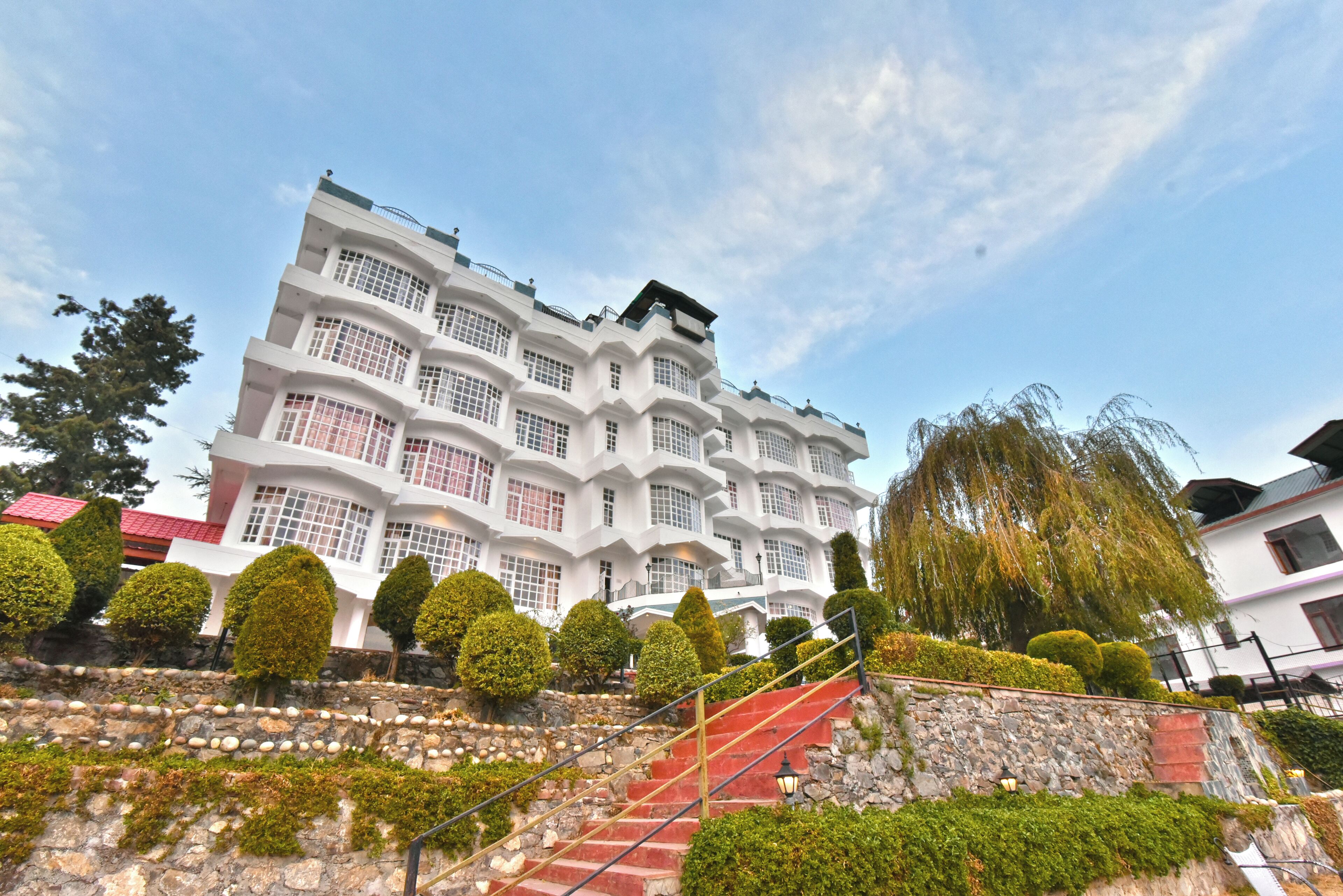 A multi-story building with a unique architectural design, featuring a series of balconies and large windows.