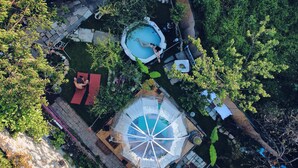 A rooftop pool area with a hot tub, a covered seating area, and a small garden. - Sky Room Carrara hydromassage with parking (Carrara)