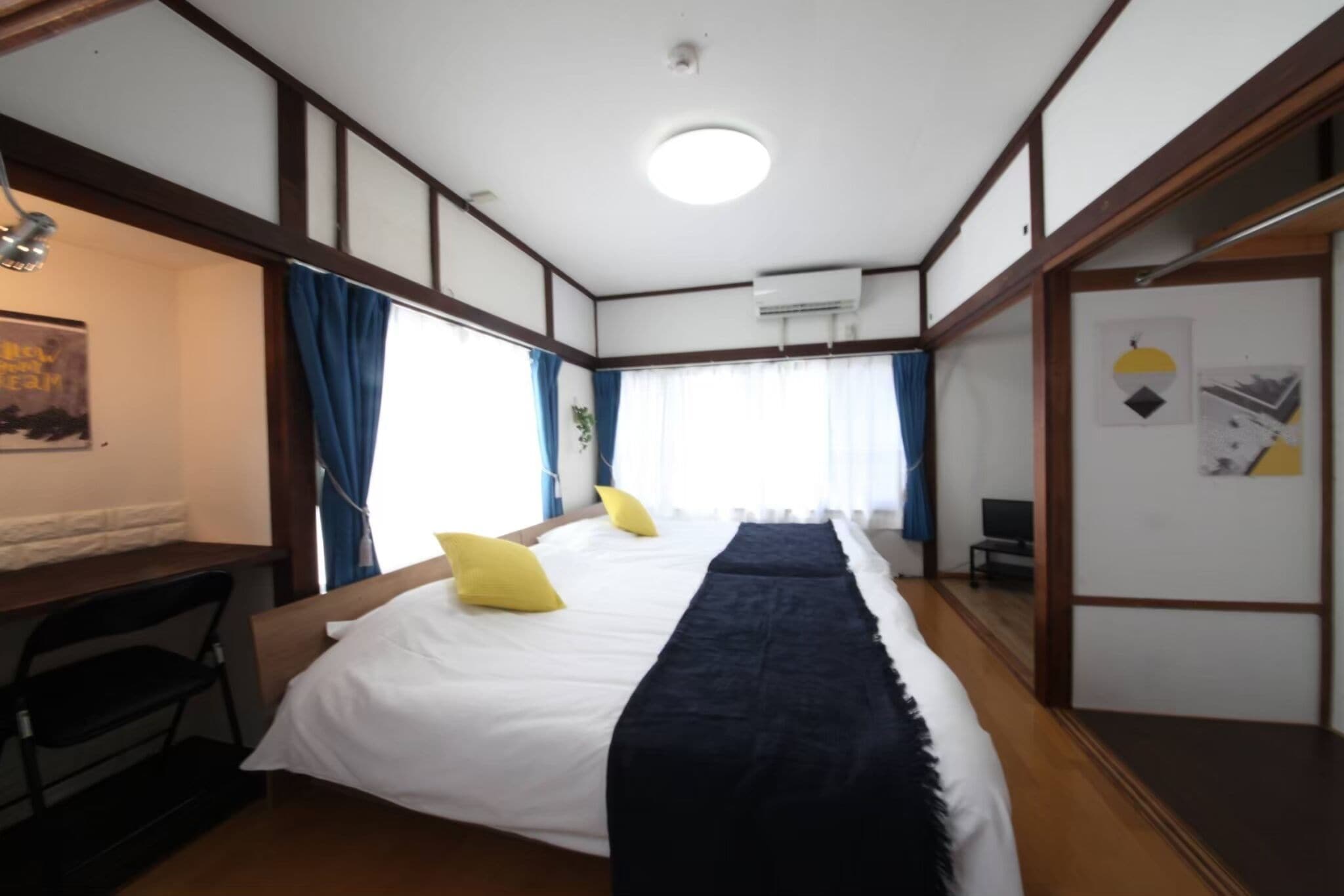 A room with a bed, a desk, and a chair.