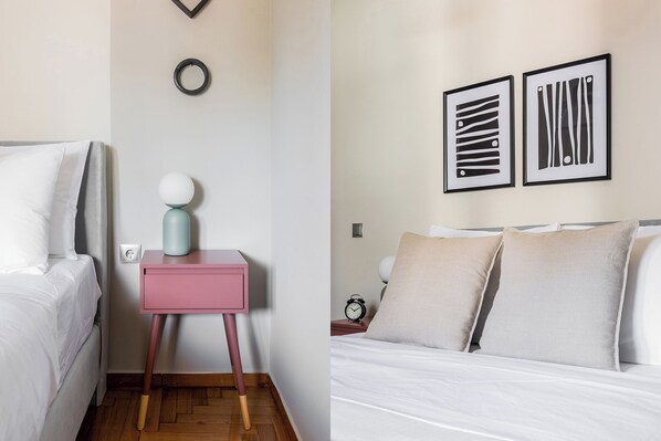 Une chambre à coucher comprenant un lit, une table de chevet et deux œuvres d’art accrochées au mur.