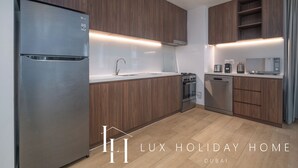 A modern kitchen with wooden cabinets, stainless steel appliances, and a built-in oven.