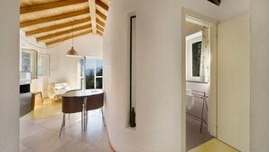 Moderni sisustus, jossa on ruokailutila, keittiö ja kylpyhuone.