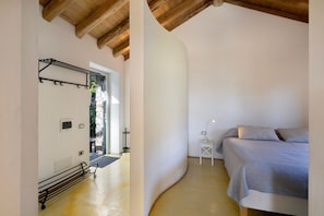 Ein Schlafzimmer mit einem Bett, einem Nachttisch und einem Wandregal.