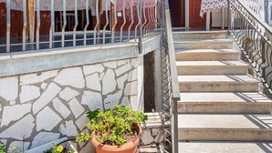 A building with a stone facade, a metal railing, and a staircase leading to an upper level. - Villa 'Lucia' with Shared Terrace and Wi-Fi (Minturno)
